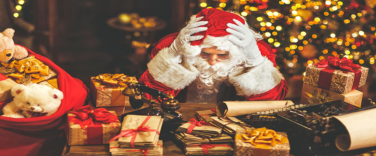 Stressed Santa surrounded by presents on Christmas Day